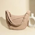 Detail of beige corduroy crescent bag showing striped texture and woven zipper pull - Khaki