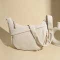 Minimalist beige corduroy crescent shoulder bag with a stylish woven zipper pull - Off-white