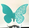 Detailed teal 3D butterfly place card with intricate laser-cut lace pattern on a glass - Tiffany Blue