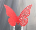 Close-up of red laser-cut butterfly glass card with elegant rose hollow pattern details - Red