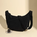 Detailed close-up of black corduroy hobo bag featuring woven rope zipper pulls - Black