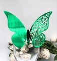 Detail of laser-cut green butterfly place card on wine glass with floral background - Reflective Green