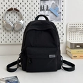 Minimalist black waterproof nylon backpack with front pocket for travel and daily use - Black