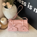 Pink pleated leather shoulder bag with bows and stud details in a lifestyle setting - Pink