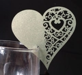 Macro shot of laser-cut champagne gold heart wine glass cards with floral pattern - Silver Charcoal