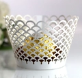 Macro detail of laser-cut white cupcake wrapper featuring elegant fish scale pattern - White