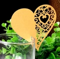Close-up of heart-shaped laser-cut place cards on a glass for wedding decor - Gold