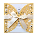Detailed laser-cut butterfly invitation cover with elegant white satin ribbon and bow - Gold