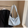 Detail of light blue quilted shoulder bag with wide strap and small metal logo plate - One Size / Blue