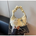 Detail of yellow crescent bag featuring monogram embossing and a scrunchie handle - Yellow with Pendant