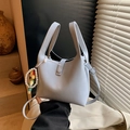Light blue faux leather bucket bag with dual handles and elegant pearl charm detail - Blue with Charm