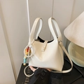 Chic cream white bucket bag with elegant pearl charm and crossbody strap accessory - White with Pendant