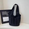 Minimalist black canvas tote bag with multi-pocket design and wide shoulder straps - Black