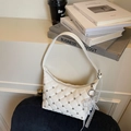 White quilted faux leather shoulder bag with studs and pearl bow charm detail - Cream White With Pendant
