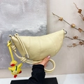 Light yellow lychee leather crescent bag with rope knot handle and duck pendant charm - Lemon Yellow With Pendant
