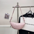 Pale pink leather croissant bag with woven knot strap on a stylish metal display stand - Rose Pink without Pendant