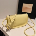 Borsa a sella gialla in pelle con motivo litchi, tracolla intrecciata e ciondolo cuore - Giallo