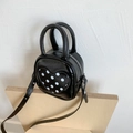 Detail view of mini bucket bag with polka dot heart pattern and metallic rivets - Black