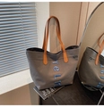 Detail of grey canvas tote bag with brown leather handles and blue embroidered letters - Dark Brown