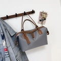 Grey nylon tote bag with brown leather trim hanging on a wooden hook in a chic scene - Small / Gray