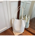 Detail of white crocodile embossed bucket bag featuring elegant leather shoulder straps - White