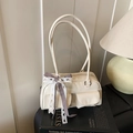 Creamy white chic shoulder bag with double front pockets and lace bow charm - White