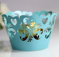 Close-up of laser-cut paper cupcake wrappers featuring heart and bird patterns in light blue - Tiffany Blue