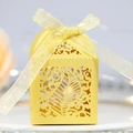 Elegant gold hollow leaf candy box with pearlescent finish and a satin ribbon bow - Gold