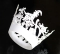 Close-up of laser-cut white paper cupcake wrappers featuring Halloween witch and pumpkin - 5x5x8CM / White