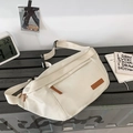 Off-white large capacity crossbody sling bag with leather patch on a textured bench - White