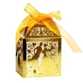 Macro detail of laser-cut gold wedding favor box with bride and groom silhouette - Reflective Gold