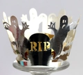Macro detail of silver laser-cut Halloween cupcake wrapper with RIP and ghost design - Reflective Silver