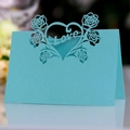 Macro detail of laser-cut blue pearlescent paper table card with Love heart and roses - Tiffany Blue