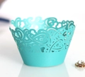 Macro view of Tiffany blue laser-cut cupcake wrapper with intricate vine patterns - Tiffany Blue