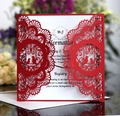 Detail of red laser cut wedding invitation with intricate lace birds and white insert - Red