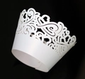 Detailed laser-cut white cupcake wrapper with heart lace pattern on a black background - White