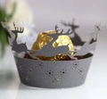 Macro view of laser-cut grey cupcake wrapper featuring reindeer and snowflake patterns - Silver Charcoal