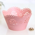 Pink cupcake wrapper with laser-cut rose patterns and elegant wavy scalloped edges - Pink
