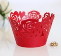 Close-up of laser-cut red rose cupcake wrappers with heart-shaped patterns for parties - Pearlescent Red