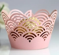 Macro detail of laser-cut pink cupcake wrapper with elegant scalloped pattern and texture - Pink