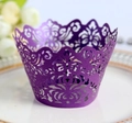 Close-up of laser-cut purple cupcake wrapper with elegant floral vine pattern on a plate - Dark Purple