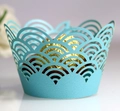 Detail of light blue laser-cut cupcake wrapper with intricate scalloped cloud pattern - Tiffany Blue