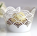 White laser-cut cupcake wrappers with scalloped patterns for elegant party decorations - White