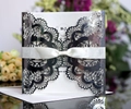 Detail of silver laser-cut wedding invitation with elegant ivory ribbon and lace patterns - Reflective Silver
