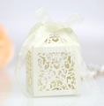 Detail of laser-cut heart pattern on cream wedding candy box with organza ribbon bow - Ivory