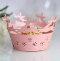 Detailed laser-cut pink paper cupcake wrapper featuring reindeer and snowflake patterns - Pink