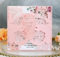 Detail of pink laser-cut floral wedding invitation with elegant botanical insert - Pink