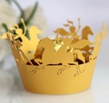 Detail of laser-cut gold cupcake wrapper with horse pattern and chocolate center - Gold