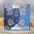 Detail of laser-cut hollow wedding invitation with navy glitter cover and floral insert - Magic Blue