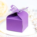 Detail of purple kraft paper candy box featuring a hollow butterfly cutout on a white plate - Dark Purple